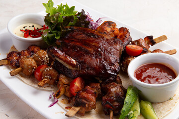 Assorted grilled meats. On a light background.