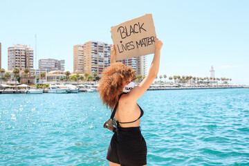 African American woman protesting with black lives matter poster