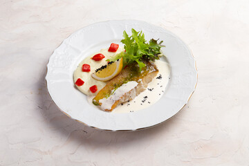 Fried cod and sauce in a bowl.