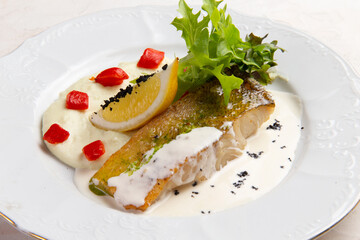 Fried cod and sauce in a bowl.