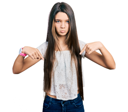 Young brunette girl with long hair wearing white shirt pointing down looking sad and upset, indicating direction with fingers, unhappy and depressed. - Powered by Adobe