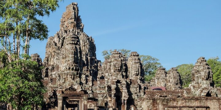Image of the famous Bayon Temple in Cambodia on a sunny warm day, known for its architecture.