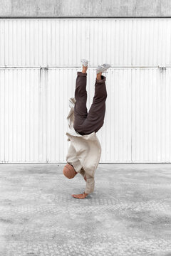 Male break dancer performing on street