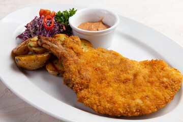 Deep fried turkey leg in a plate.