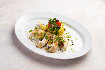 Stuffed squid in a bowl. On a light background.