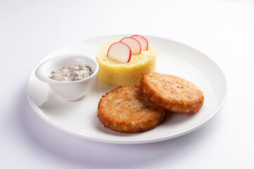 Cutlets and mashed potatoes in a plate.