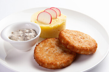 Cutlets and mashed potatoes in a plate.