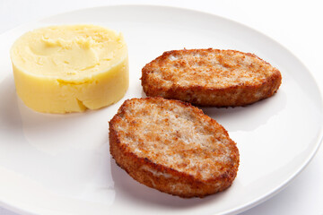 Cutlets and mashed potatoes in a plate.