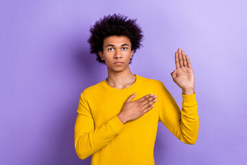 Photo of focused concentrated young person arm touch heart raise palm swear promise isolated on violet color background - obrazy, fototapety, plakaty