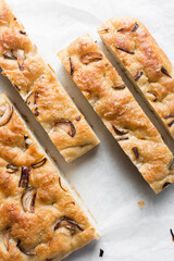 Top view of homemade onion focaccia on a white background, Flatlay of focaccia with red onion topping, fresh homemade focaccia bread