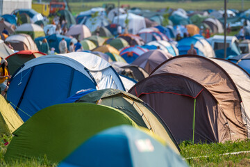 Multicolored tents on music festival campsite at park
