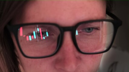 Сlose up of woman wearing the glasses keeps an eye on the changing numbers stock financial charts, augmented reality, technology, stock exchange and finance.
