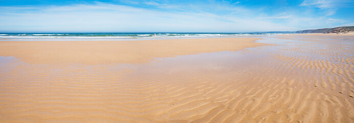 Fototapeta na wymiar rippled sandy wide Bordeira beach, West Algarve Portugal
