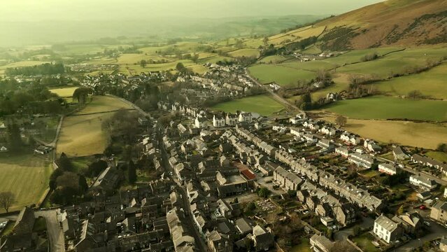 Behold the dramatic allure of the rural Cumbrian countryside through captivating drone footage, capturing the small English town of Sedbergh on the edge of the Yorkshire Dales