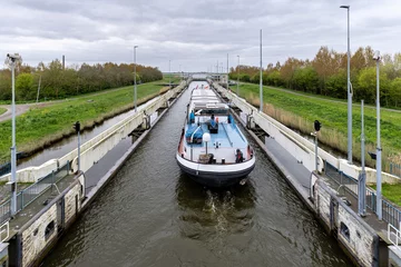 Fotobehang inland general cargo vessel in the Prinses Margrietsluis in Lemmer, Netherlands © Björn Wylezich