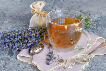 Fresh delicious tea with lavender and lavender flowers on gray stone table - 623184244