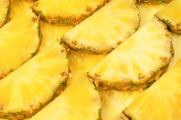 Pineapple juicy yellow slices as a background.