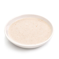 Bowl of fresh garlic dip sauce on white background