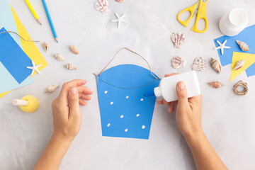 Paper bucket of shells summer idea for kids craft in kindergarten hands ocean's day