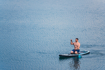 man on paddleboard in the middle of the lake