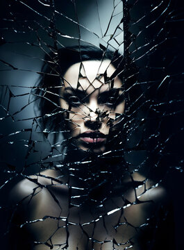 Fashion surreal Concept. Stunning beautiful woman of a shattered cracked mirror. illuminated with dynamic composition and dramatic lighting. sensual, mysterious, advertisement, magazine
