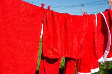 The Santa Claus costume dries on a rope.