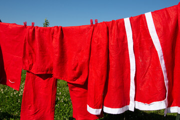 The Santa Claus costume dries on a rope.