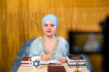 A Jewish woman in a kisui rosh headdress, a teacher of tradition, prepares for classes for women.