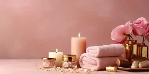 Poster Beauty treatment items for spa procedures on pink wooden table and gold marble wall. massage stones, essential oils and sea salt. candle, rolled up white towel, plants, copy space © Savinus