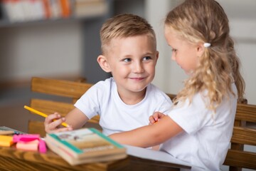 Children reading books sitting for table