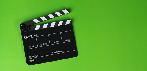 Clapper board or movie slate on green background.. - obrazy, fototapety, plakaty
