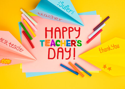 Childish lettering for Teachers' Day. Appreciation of teachers top view flat lay concept. Colored paper, multi-coloured letters, supplies