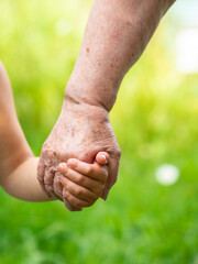 Grandma holding grandchild hand