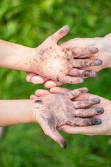 Fototapeta premium Little girl showing dirty hands to her granny