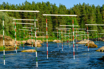Fototapeta premium Canoe slalom course gate with paddler background. River Gauja Latvia. City Valmiera