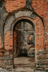 Entrance to an abandoned old ruin. Old walls falling apart
