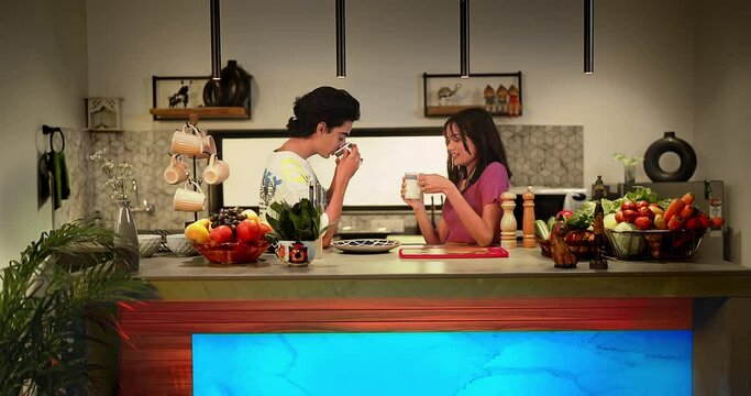 Indian asian happy beautiful 2 two teena couple standing together in modern home kitchen hold cup mug drink coffee. Smiling boyfriend boy slim girl friend take hot tea sips talk enjoy fun spend time