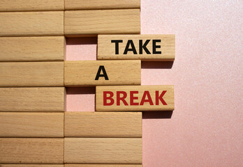 Take a break symbol. Concept words Take a break on wooden blocks. Beautiful pink background. Business and Take a break concept. Copy space.