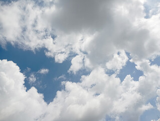 Obraz premium blue sky with white cloud background,Bfluffy cloud in the blue sky background,Clearing day and Good weather in the morning.meteorology, heaven, hope, peace, graphic resources, picturesque panoramic sc