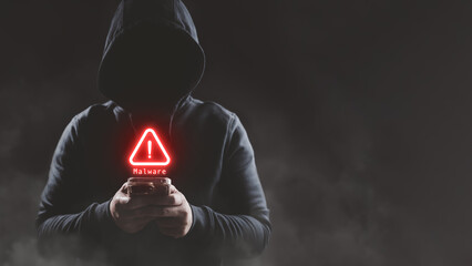 Hacker wear hood holding smartphone with red warning icon to launch ransomware malware attack on...