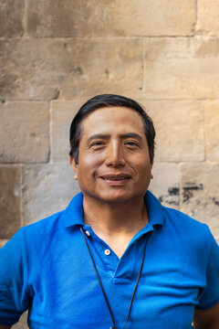 Street portrait of a smiling Peruvian man in the city of Barcelona (Spain).
