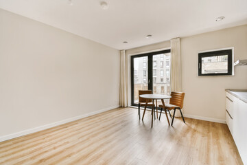 an empty living room with wood flooring and large windows in the room is clean and ready for guests to use