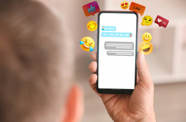 Man with mobile phone chatting online, closeup