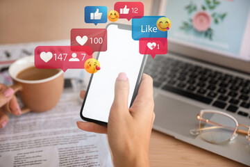 Woman with mobile phone chatting online at workplace