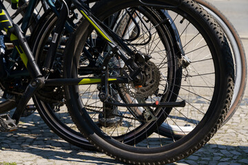 Bicycle wheels close-up in the parking lot for bicycles.