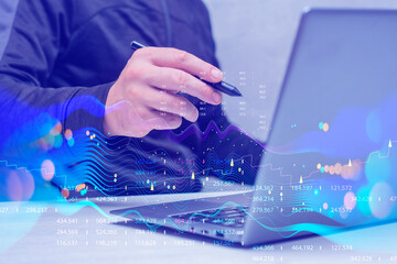 Businessman with laptop analyzes financial market data. Futuristic technology solution for business development. Abstract technological background in vibrant colors with blur.