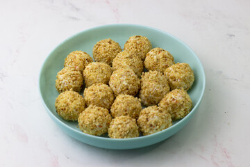 An appetizer for the festive table. Aperitif. Cheese balls in peanut crumbs