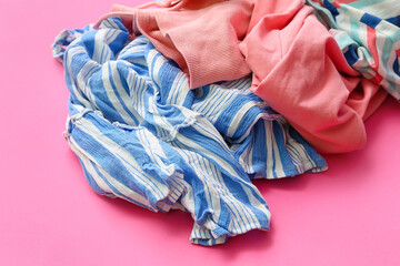 Pile of dirty clothes on pink background