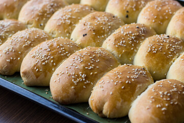 Homemade pies sprinkled with sesame seeds. Appetizing homemade cakes