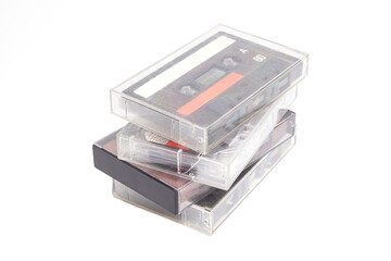 Stack of vintage audio cassettes isolated on white.